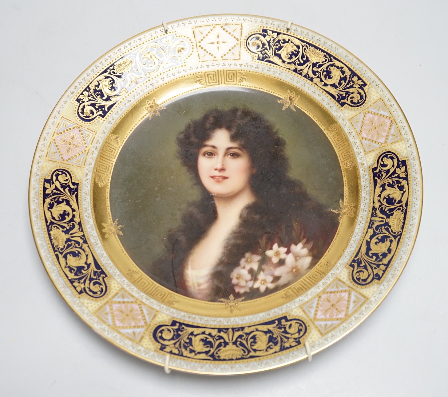 A Vienna cabinet plate with portrait painting to centre, underglaze blue beehive mark to reverse. 24cm diameter